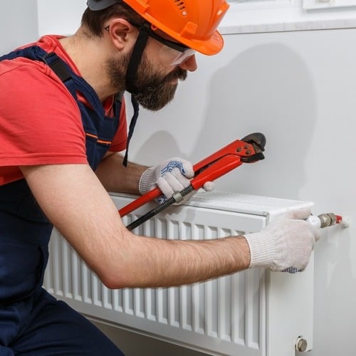 a worker installing a radiator