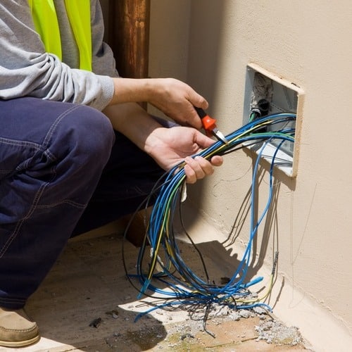 close-up of an electrician working on wiring in a home