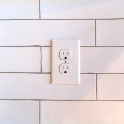 an outlet on a white wall